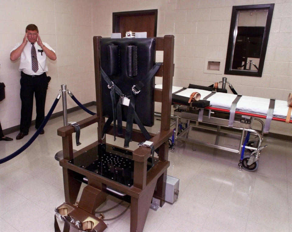 FILE - In an Oct. 13, 1999 file photo, Ricky Bell, then the warden at Riverbend Maximum Security Institution in Nashville, Tenn., gives a tour of the prison's execution chamber. Tennessee has set two new execution dates, just days after putting to death its seventh inmate in the past year-and-a-half. On Monday, Feb. 24, 2020 the Tennessee Supreme Court ordered an Oct. 8 execution date for inmate Byron Black and a Dec. 3 execution date for Pervis Payne. (AP Photo/Mark Humphrey, File)