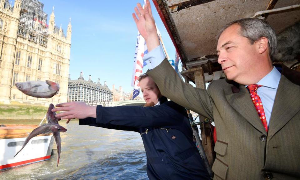 Brexit campaigner Nigel Farage and the founder of Fishing for Leave, Aaron Brown, dump fish in the Thames next to the Houses of Parliament on 21 March.