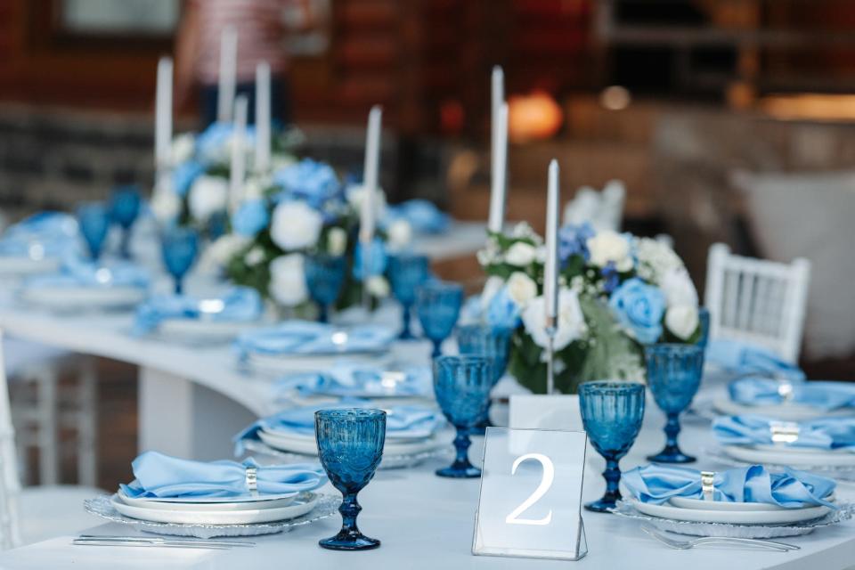 A wedding tablescape with blue dishes and linens