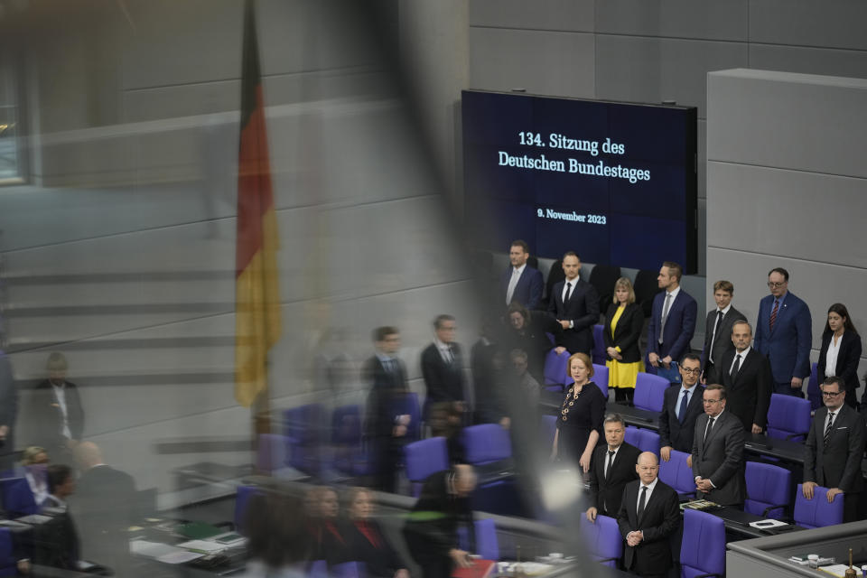 German Chancellor Olaf Scholz, bottom right, arrives for a debate at the parliament Bundestag about antisemitism and the protection of Jewish life in Germany, on the 85th anniversary of the November 1938 progroms in Germany and Austria, in central Berlin, Germany, Thursday, Nov. 9, 2023. According to Israel's Yad Vashem Holocaust memorial, the Nazis killed at least 91 people, vandalized 7,500 Jewish businesses and burned more than 1,400 synagogues during Nov. 9, 1938 pogroms known as Kristallnacht or 'Night of broken Glass'. (AP Photo/Markus Schreiber)