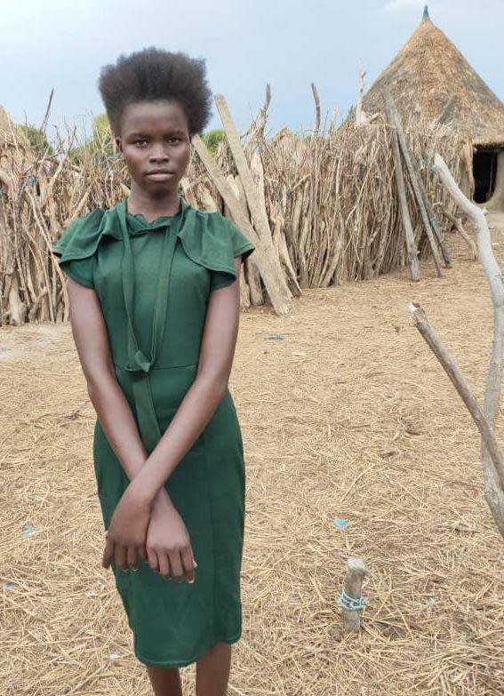 Nyekuoth Manyuan, 14, is seen in   her village of Kueryiek, South Sudan, without the makeup and wig she put on later for her arranged marriage to a 25-year-old man. She was sold into marriage by her starving family for a dowry of 60 cattle. / Credit: CBS News