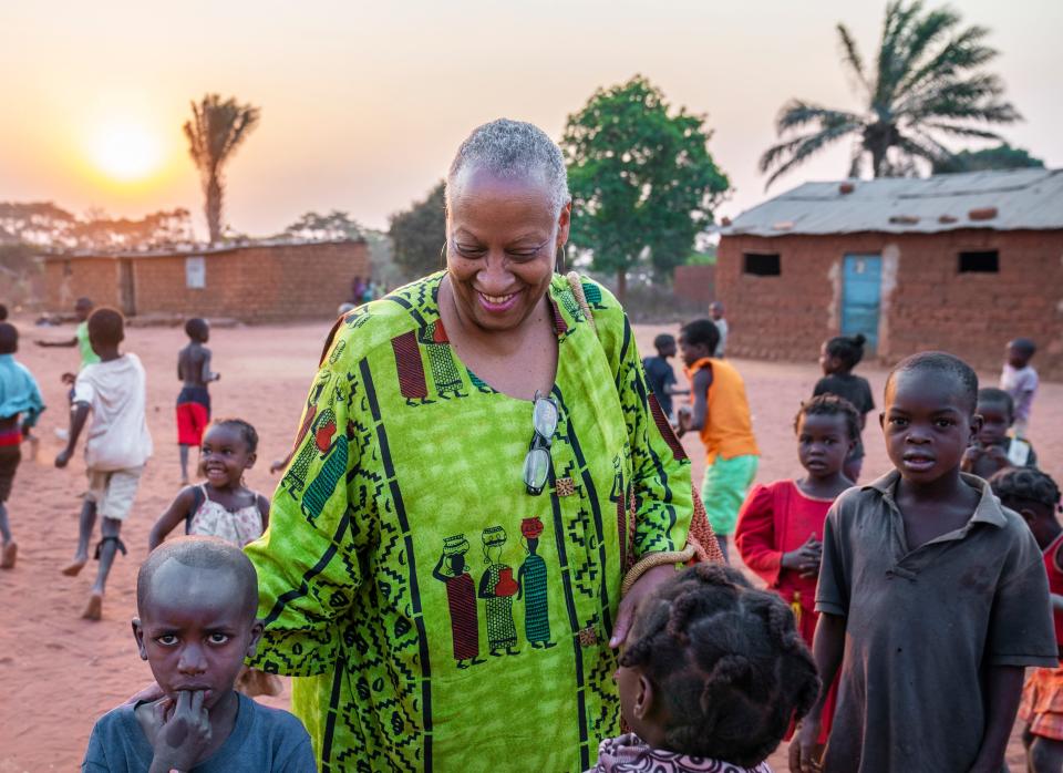 Wanda Tucker hugs children from a village in Kalandula.