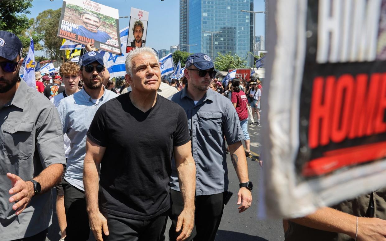 Israeli opposition leader Yair Lapid attends a rally by families and supporters of hostages