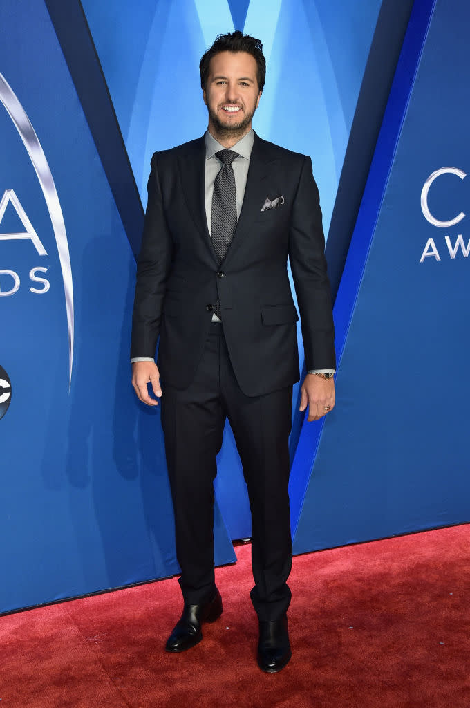 <p>Bryan quickly changed out of his red carpet attire and into a coated denim jacket for his performance. (Photo: Getty Images) </p>