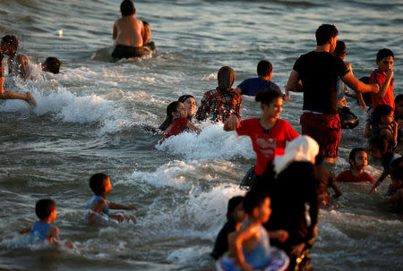 Palestinians dip in the Mediterranean Sea to cool off on a hot day in Gaza City. REUTERS/Suhaib Salem