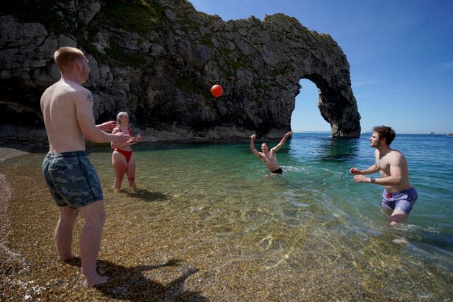 A group of friends enjoy the hot weather with a game of volleyball