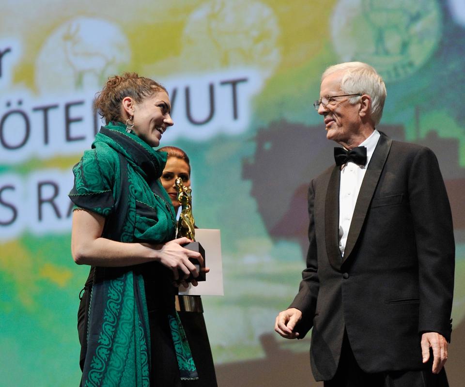 DUBAI, UNITED ARAB EMIRATES - DECEMBER 16: Director Pary El-Qalqili with the Muhr Arab Documentary Best Film award on stage during the Closing Ceremony on day eight of the 9th Annual Dubai International Film Festival held at the Madinat Jumeriah Complex on December 16, 2012 in Dubai, United Arab Emirates. (Photo by Gareth Cattermole/Getty Images for DIFF)