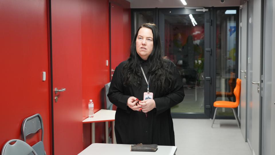 Lyudmyla Tabolina, principal of Inventor School Kyiv, stands in a hallway of the school on Feb. 13, 2023.