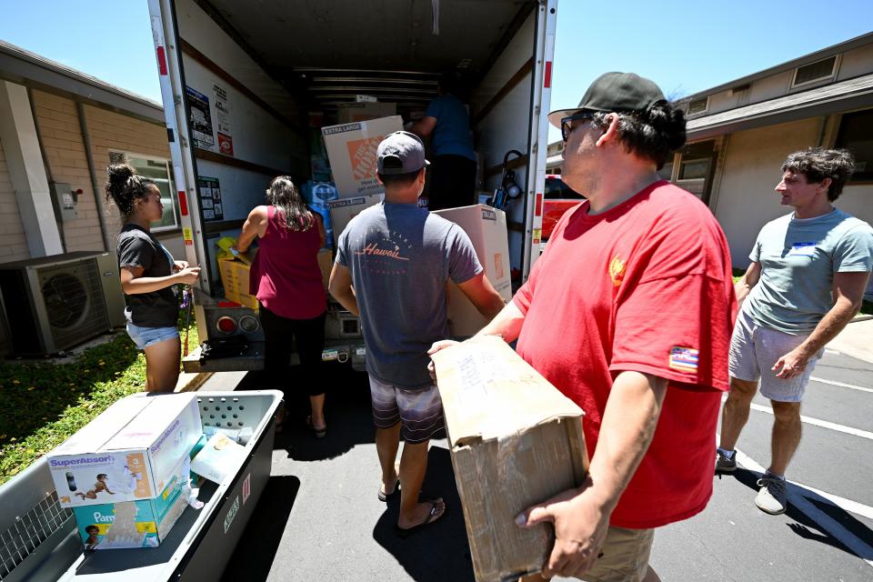 Volunteers unload a U-Haul truck with items from Hilo, Hawaii, as response to the Maui fire, which destroyed a large portion of the town of Lahaina, continues to come in from neighboring islands and the mainland on Thursday, Aug. 17, 2023. | Scott G Winterton, Deseret News