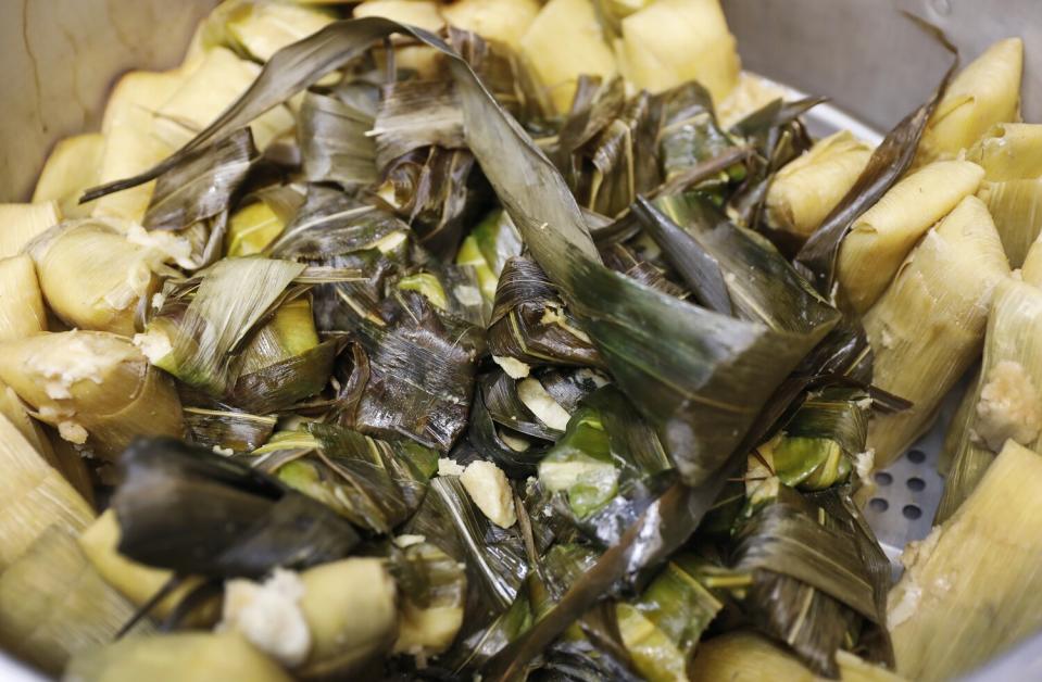 Corundas tamales in the center surrounded by Uchepo tamales