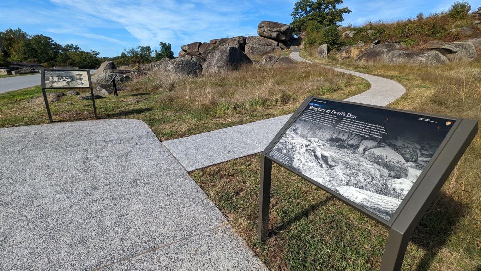 A new sidewalk leads visitors though the boulders of Devil's Den at the Gettysburg National Military Park on October 6, 2022. The popular spot reopened recently after it had been closed since March.