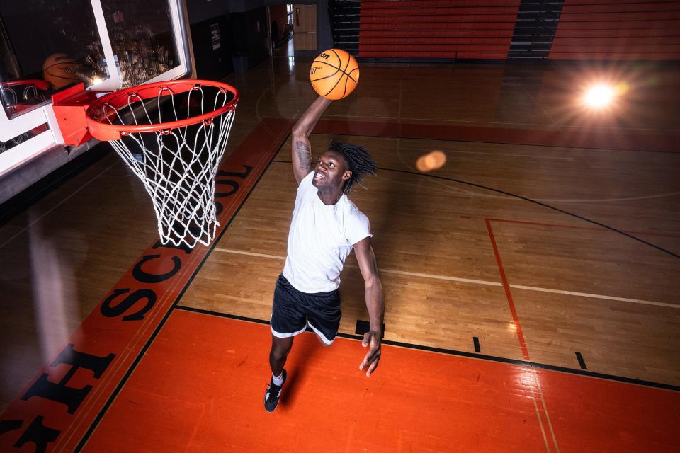 North High senior captain Joe Okla dunks the ball during a recent practice as the Polar Bears prepare for the state playoffs.