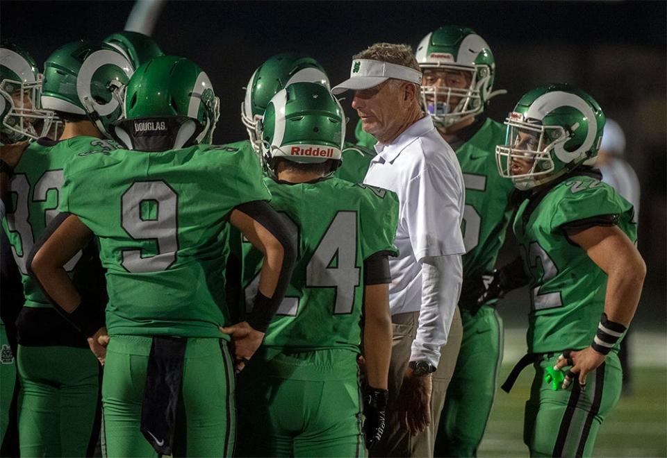 St. Mary's head coach Tony Franks talks with his team before the kickoff of  a varsity football game against Cardinal Newman Sept. 24 at St. Mary's Sanguinetti Field in Stockton.