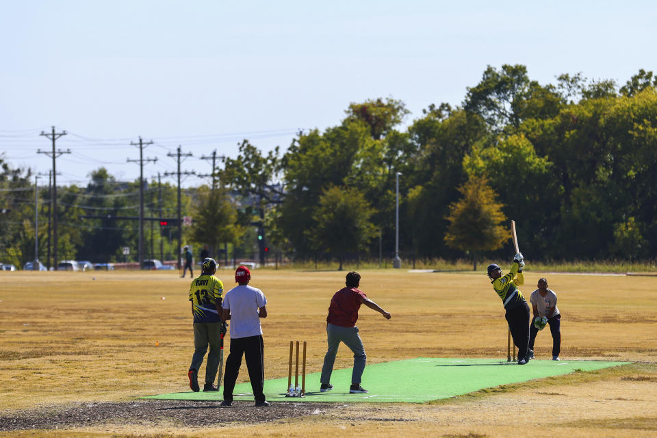 A batsman attempts to hit a ball during a cricket match between the Dallas Cricket Connections and the Kingswood Cricket Club on a field adjacent to Roach Middle School in Frisco, Texas, Saturday, Oct. 22, 2022. The teams play in the City of Frisco Cricket league. (AP Photo/Andy Jacobsohn)