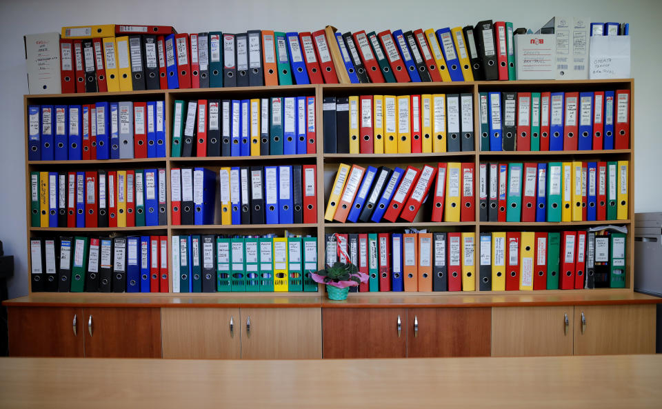 In this picture taken Tuesday, May 21, 2019, folders containing documentation for European Union funded projects are stored in Luncavita, Romania, Tuesday, May 21, 2019. The Romanian village of Luncavita has benefited greatly from millions in development funds from the European Union, but few of its residents bothered to vote in previous European Parliamentary elections. (AP Photo/Vadim Ghirda)