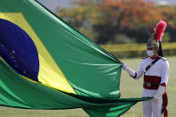 A soldier from the Presidential Guard Battalion takes part in a national flag-raising ceremony outside the presidential official residence, Alvorada Palace, in Brasilia, Brazil, Tuesday, Oct. 27, 2020, amid the COVID-19 pandemic. (AP Photo/Eraldo Peres)