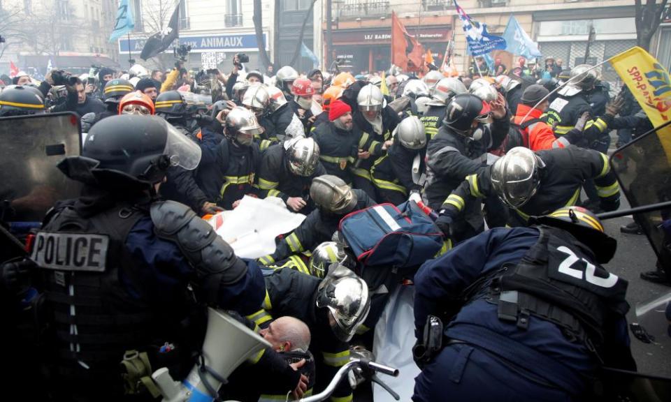 French firefighters face off with French riot police as they demonstrate to protest against working conditions in Paris on 28 January