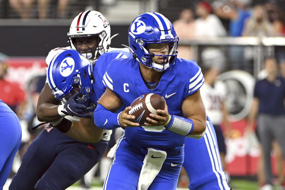 BYU quarterback Jaren Hall looks to hand off the ball against Arizona during the second half of an NCAA college football game Saturday, Sept. 4, 2021, in Las Vegas. (AP Photo/David Becker)