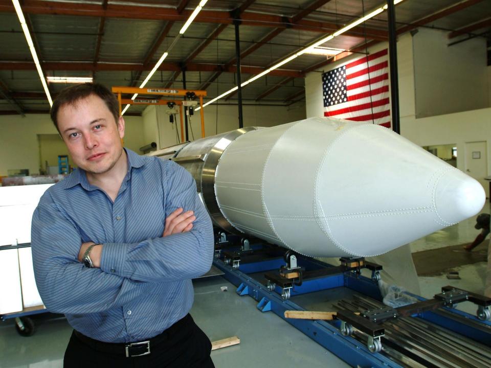 Elon Musk, the founder of SpaceX, stands beside a rocket in Los Angeles in 2004.