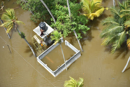 People wait for rescue teams on top of a building in a village in Matara, Sri Lanka May 29, 2017. Sri Lanka Air Force/Handout via REUTERS