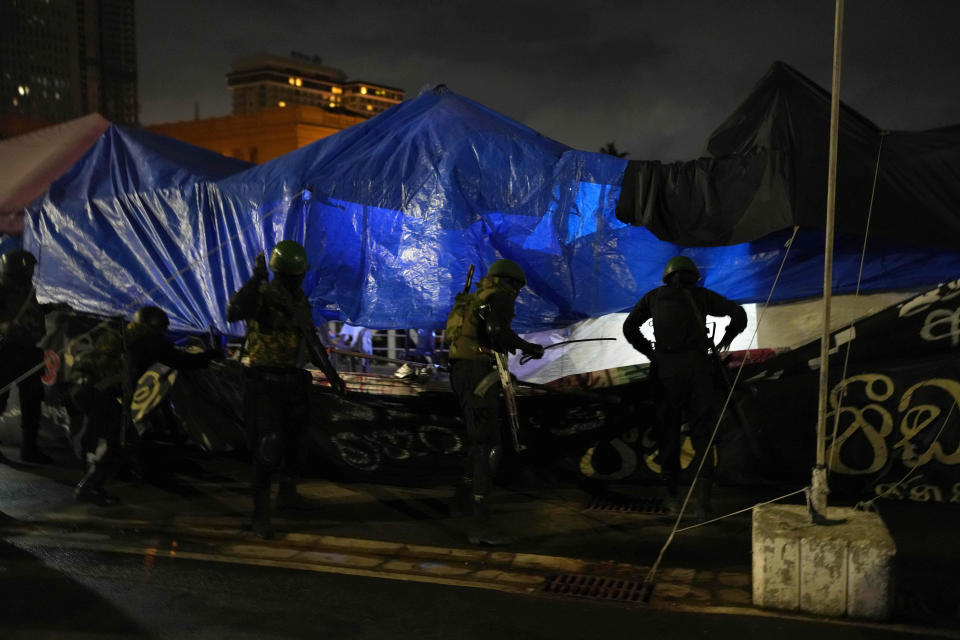 Army soldiers remove protesters' tents from the site of a protest camp outside the Presidential Secretariat in Colombo, Sri Lanka, Friday, July 22, 2022. (AP Photo/Rafiq Maqbool)