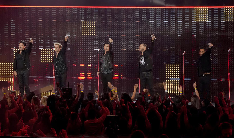 Jonathan Knight, from left, Joey McIntyre, Jordan Knight, Donnie Wahlberg and Danny Wood of New Kids on the Block perform a medley at the American Music Awards on Sunday, Nov. 21, 2021 at Microsoft Theater in Los Angeles. (AP Photo/Chris Pizzello)