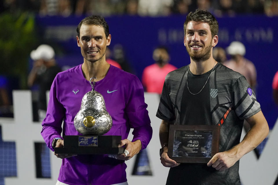 Spain's Rafael Nadal, left, and Britain's Cameron Norrie pose with their trophies after the final match at the Mexican Open tennis tournament in Acapulco, Mexico, Saturday, Feb. 26, 2022. (AP Photo/Eduardo Verdugo)