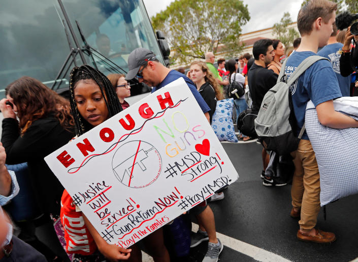 <p>Tyra Hemans, 19, left, and Logan Locke, 17, right, students who survived the shooting at Stoneman Douglas High School, wait to board buses in Parkland, Fla., Tuesday, Feb. 20, 2018. The students plan to hold a rally Wednesday in hopes that it will put pressure on the state’s Republican-controlled Legislature to consider a sweeping package of gun-control laws, something some GOP lawmakers said Monday they would consider. ( Photo: Gerald Herbert/AP) </p>