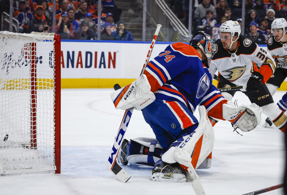 Anaheim Ducks forward Sam Carrick, right, scores against Edmonton Oilers goalie Stuart Skinner during first-period NHL hockey game action in Edmonton, Alberta, Saturday, Dec. 17, 2022. (Jeff McIntosh/The Canadian Press via AP)