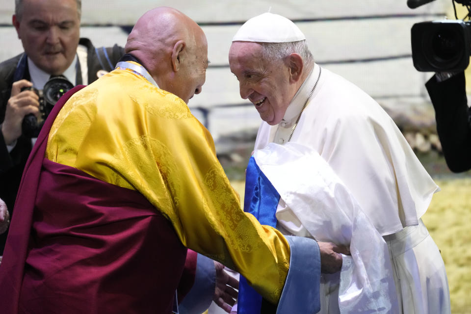 Pope Francis is welcomed by Choijiljav Dambajav, abbot of the Buddhists’ Zuun Khuree Dashichoiling Monastery in Ulaanbaatar as he arrives at a meeting with religious leaders at the Hun Theatre in the Sky Resort compound some 15 kilometers south of the Mongolian capital Ulaanbaatar, Sunday, Sept. 3, 2023. Pope Francis praised Mongolia's tradition of religious freedom dating to the times of founder Genghis Khan during the first-ever papal visit to the Asian nation. (AP Photo/Andrew Medichini)