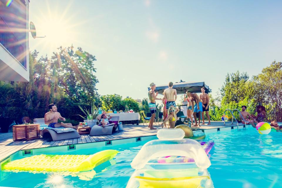 Young people in at a pool party in backyard