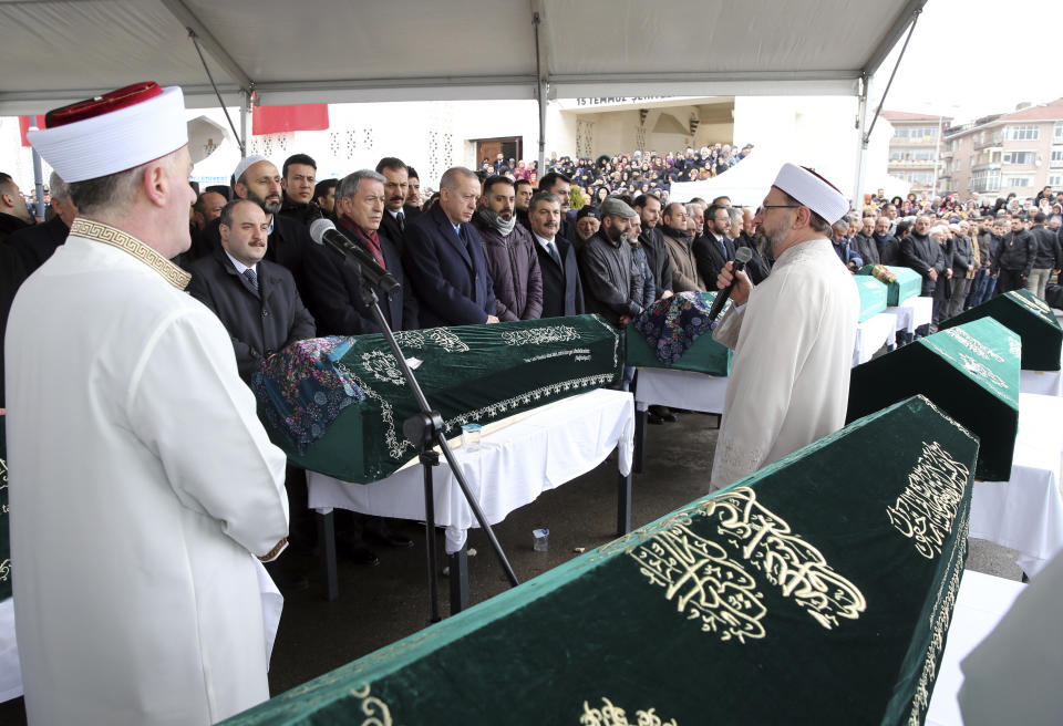 Turkey's President Recep Tayyip Erdogan, center, joins hundreds of mourners who attend the funeral prayers for nine members of Alemdar family killed in a collapsed apartment building, in Istanbul, Saturday, Feb. 9, 2019. Erdogan says there are "many lessons to learn" from the collapse of a residential building in Istanbul where at least 17 people have died.(Presidential Press Service via AP, Pool)