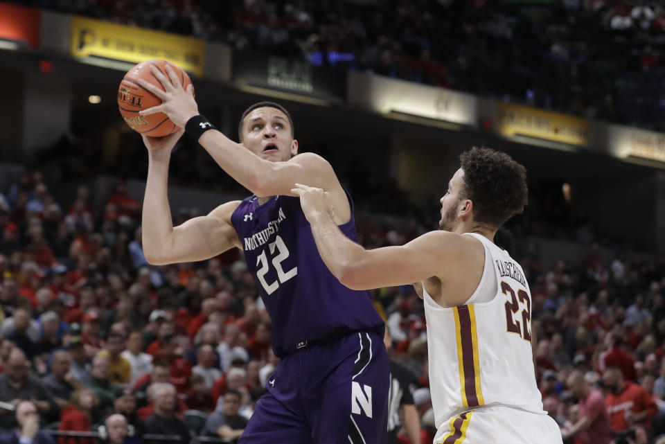 Northwestern's Pete Nance (22) shoots over Minnesota's Gabe Kalscheur (22) during the second half of an NCAA college basketball game at the Big Ten Conference tournament, Wednesday, March 11, 2020, in Indianapolis. Minnesota won 74-57. (AP Photo/Darron Cummings)