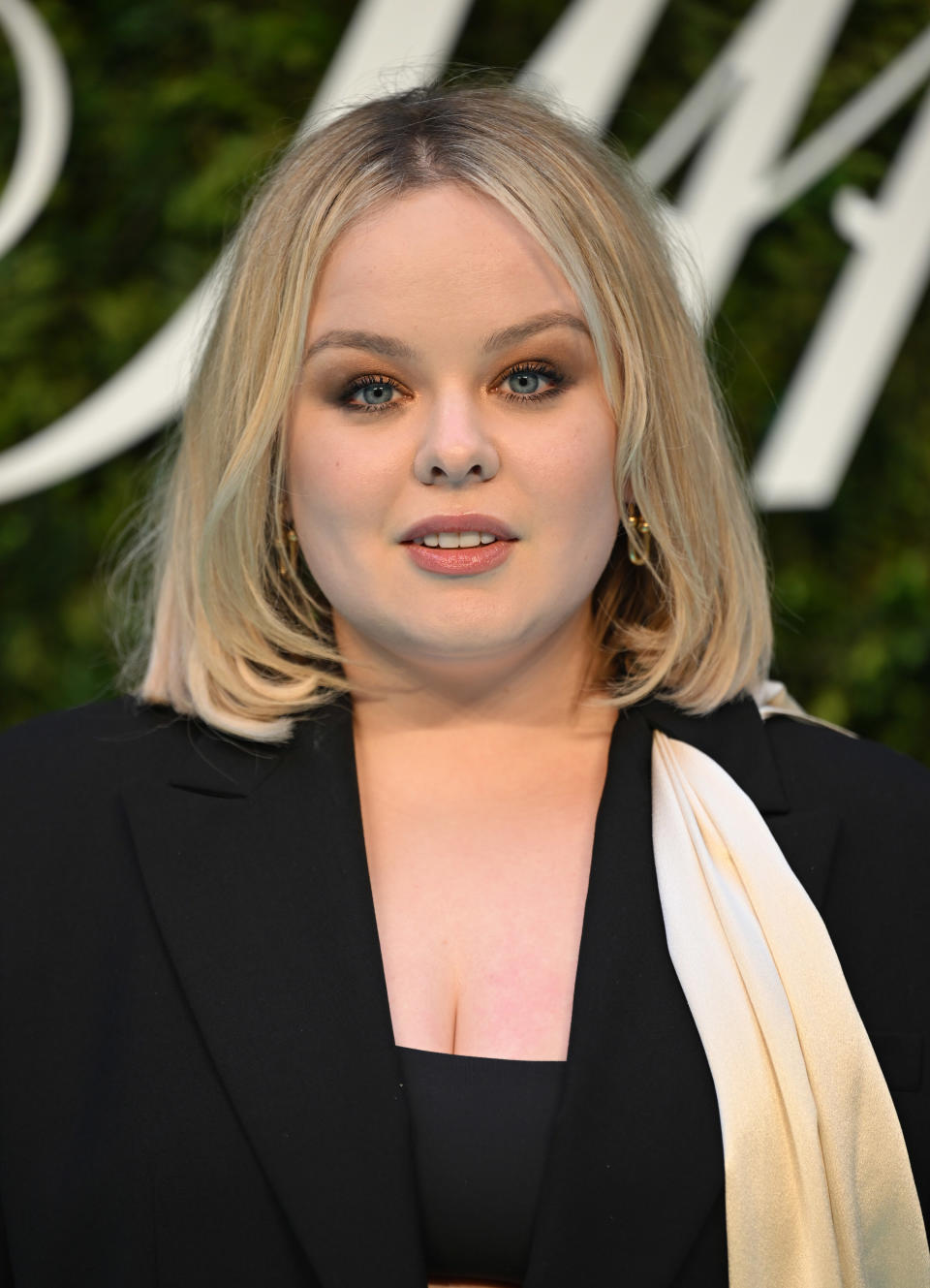 Close-up of Nicola in a square-neck top and jacket