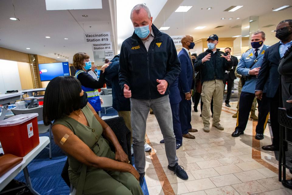 New Jersey Gov. Phil Murphy gives a thumbs-up to a resident getting vaccinated at the Burlington County mega-site inside the former Lord & Taylor at Moorestown Mall on Friday morning.