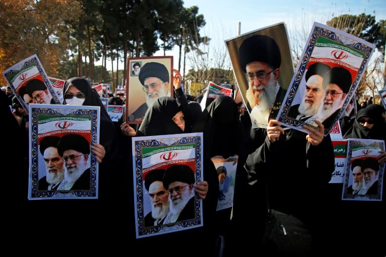 Pro-government demonstrators hold posters of Iran's supreme leader, Ayatollah Ali Khamenei (L), and the late founder of the Islamic Republic, Ayatollah Ruhollah Khomeini, in Iran's holy city of Qom on January 3, 2018