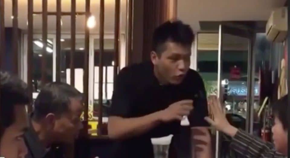 Video has emerged of the argument before a woman bit a waiter on the arm. Source: 7 News