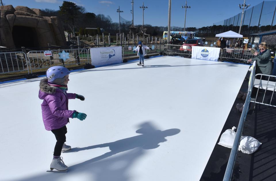Eight-year-old Emma Baker glides around on a slick plastic "ice rink" on Feb. 18 with sister Ainsley, 9, as the Yarmouth Chamber of Commerce and the Yarmouth Recreation Department put on their Winter Carnival at Skull Island on Route 28 in South Yarmouth.