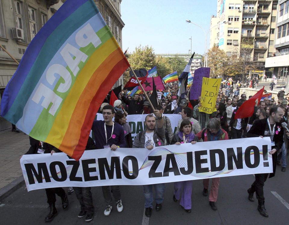 This Oct. 10, 2010 file photo shows members of the Serbian gay community marching down a street in Belgrade, Serbia. "The Parade," a black comedy made by a Serbian director, has been the biggest box office hit in the former Yugoslavia in years, even as it challenges both the region's ethnic divide and its deeply rooted homophobia. The movie has drawn more than half a million people since its release in October. It has been equally acclaimed in Serbia, Croatia and Bosnia _ something no local film has managed since the 1990s wars between the ex-Yugoslav republics. (AP Photo/Darko Vojinovic)