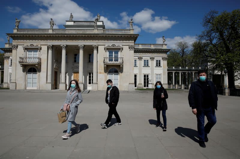 People wearing protective masks enjoy walking in the Lazienki Royal Park after loosening of the lockdown measures by the government due to the coronavirus disease (COVID-19) in Warsaw