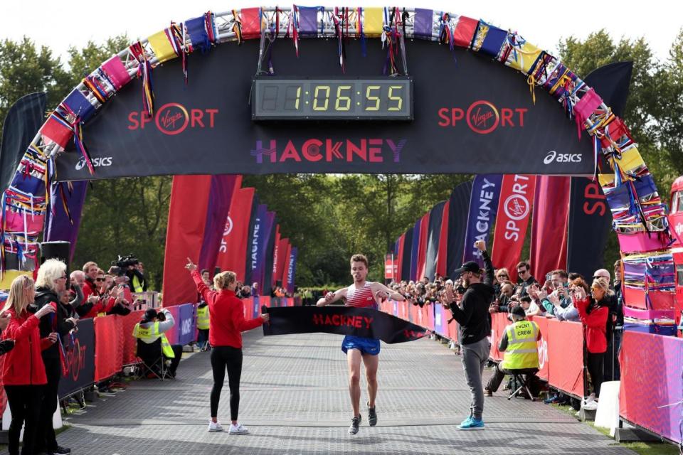 Finish: Runner Paul Whittaker crosses the line to win the half marathon (PA)