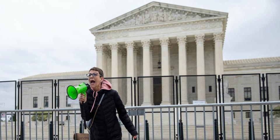 Abortion-rights protester Michele Pucciarelli addresses a crowd during a demonstration outside of the U.S. Supreme Court in Washington, Sunday, May 8, 2022