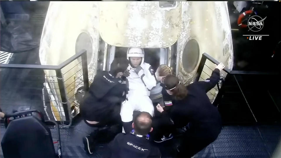 Russian cosmonaut Anna Kikina is helped out of the Crew Dragon spacecraft as she began re-adjusting to gravity after more than five months in space. / Credit: NASA/SpaceX