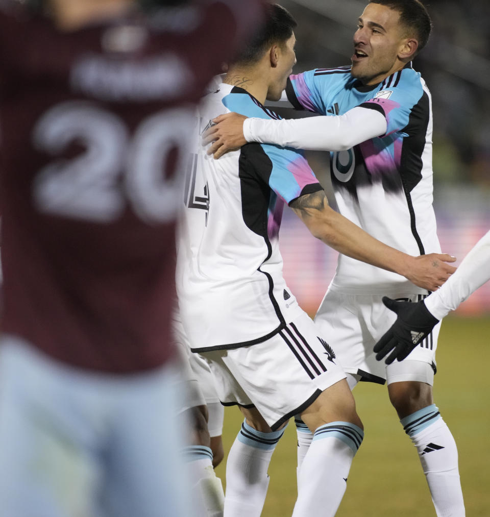 Minnesota United defender Miguel Tapias, back left, celebrates his goal against the Colorado Rapids with midfielder Franco Fragapane during the second half of an MLS soccer match Saturday, March 18, 2023, in Commerce City, Colo. (AP Photo/David Zalubowski)