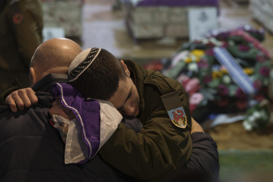 Family and friends of Israeli reservist Sgt. first class Nicholas Berger mourn during his funeral at Mt. Herzl military cemetery in Jerusalem, Israel, Wednesday, Jan. 24, 2024. Berger, 22, was killed during Israel's ground operation in the Gaza Strip, where the Israeli army has been battling Palestinian militants in the war ignited by Hamas' Oct. 7 attack into Israel. (AP Photo/Leo Correa)