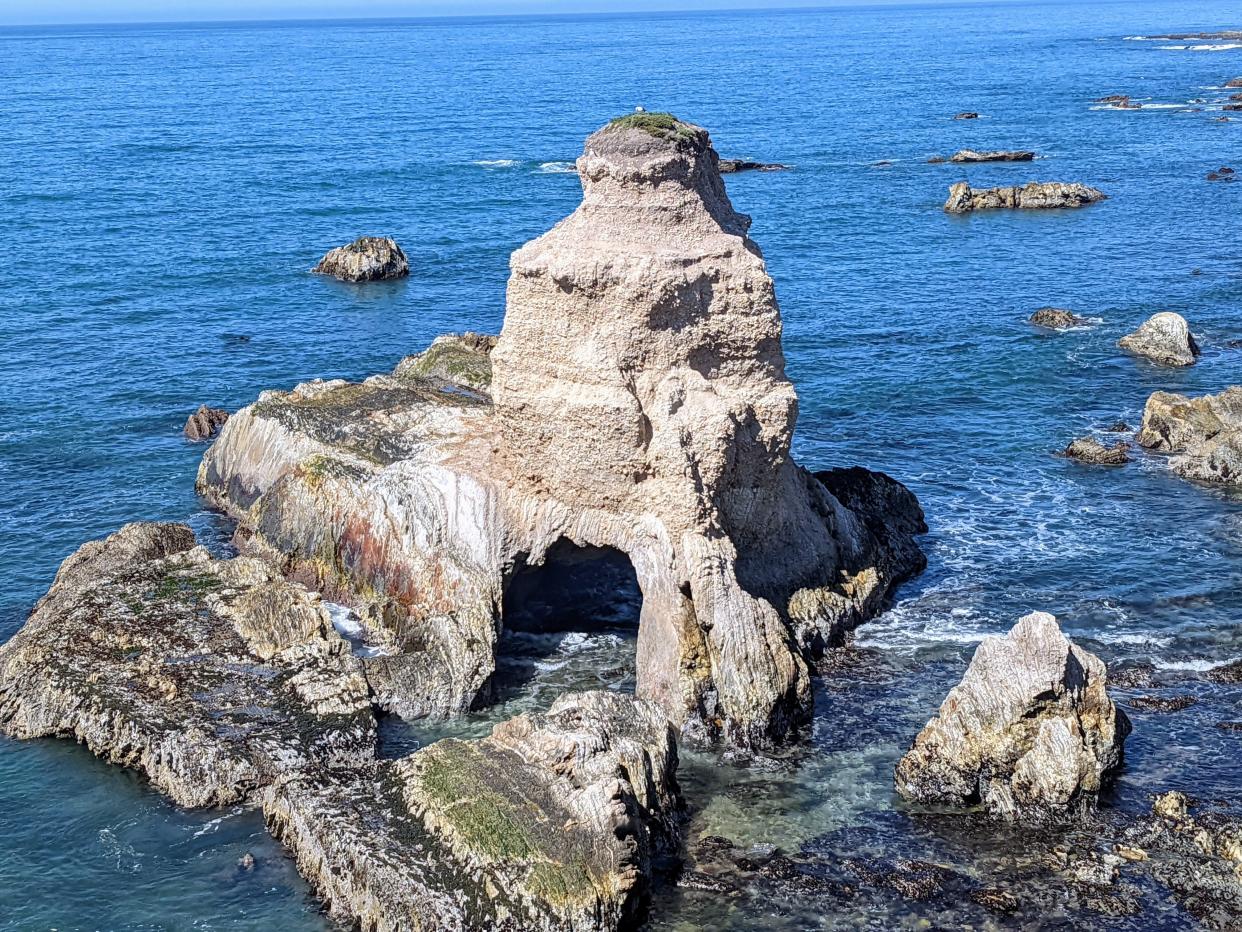 Grotto Rock at Montaña de Oro State Park is its own tiny island, but the ocean is slowly having its way with it. For the moment its partial resistance to the crashing waves makes for a spectacular sight.