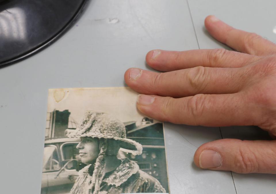 Retired Akron firefighter Larry Steele shows an early photo of himself during an interview at the Kenmore Community Center in March. Steele's first working fire as a rookie firefighter was a horrific blaze where three children perished in a Kenmore Boulevard apartment.