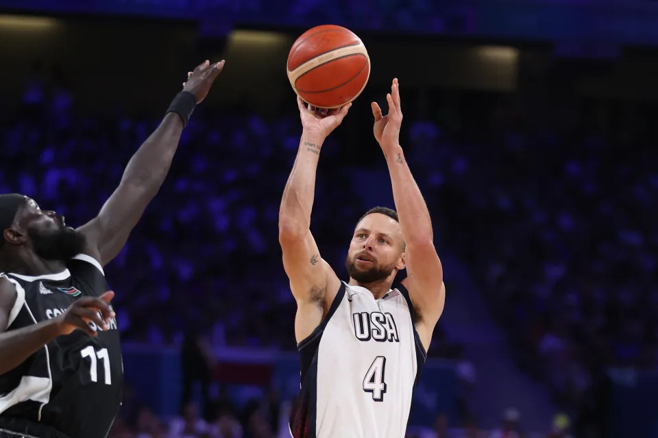 LILLE, FRANCE - JULY 31: Marial Shayok #11 of Team South Sudan shoots over Stephen Curry #4 of Team United States during a Men's Group Phase - Group C game between the United States and South Sudan on day five of the Olympic Games Paris 2024 at Stade Pierre Mauroy on July 31, 2024 in Lille, France. (Photo by Gregory Shamus/Getty Images)