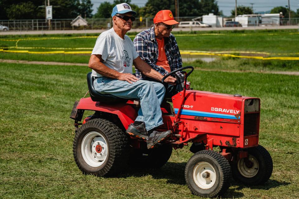 Men ride a side-by-side Gavely tractor during the annual Tuscarawas Valley Pioneer Power show, Friday Aug. 18 at the Tuscarawas County Fairgrounds in Dover. The event, which happens yearly, is also known as the Dover Steam Show.