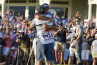 Phil Mickelson embraces his caddie after winning the final round at the PGA Championship golf tournament on the Ocean Course, Sunday, May 23, 2021, in Kiawah Island, S.C. (AP Photo/Matt York)